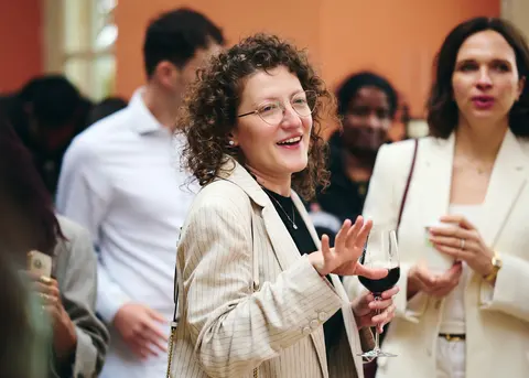 A guest smiling with a glass of champagne