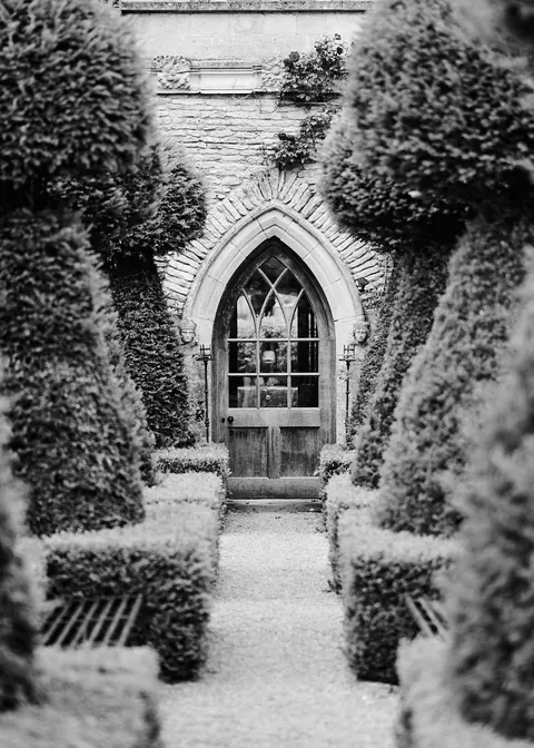 The gothic archway between the yew topiary, a wider view