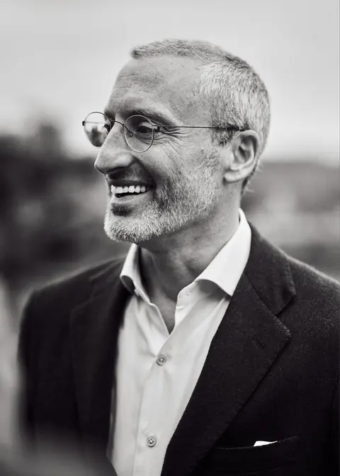 A guest in sunglasses smiling in the sun