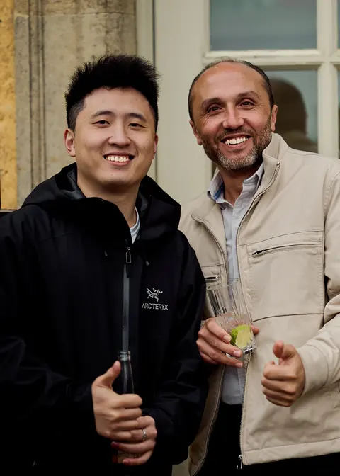Two guests laughing together on the terrace